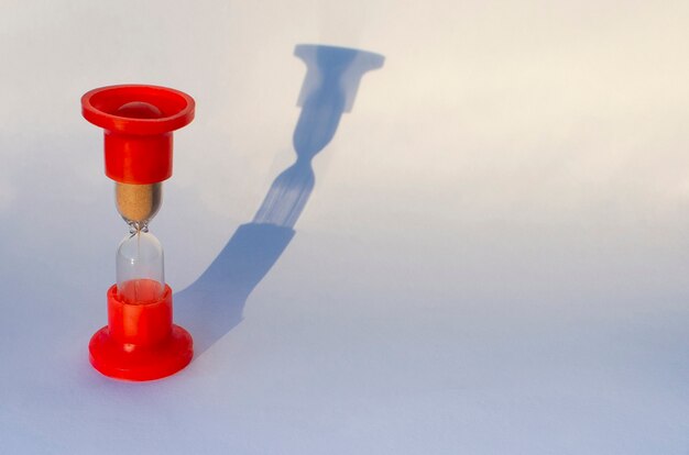 Red hourglass on gray background