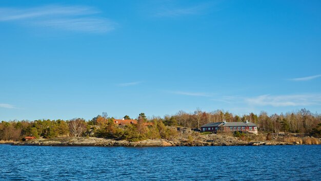 Red house at sea shore in the baltic sea in dull colors in autumn