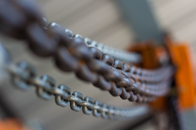 red Industrial hook hanging on reel chain and blue sky sunset background