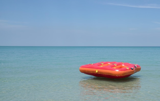 Red Inflatable ring or float in the blue sea with beautiful blue sky