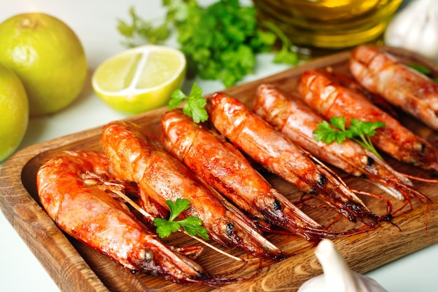 Red Langostino shrimps Prawns on a wooden board Gray background Top view Copy space High quality photo