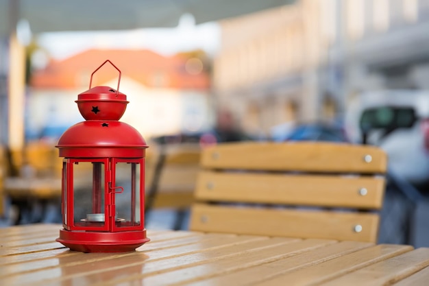 Red lantern standing on the wooden table in the city center