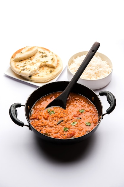 Red Lentil Cooked Dal or Dhal or Masoor daal tadka served in a bowl, selective focus