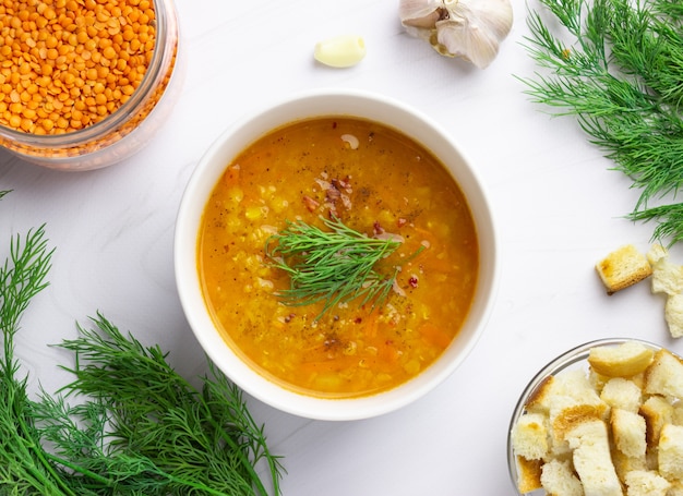 Red lentil soup with ingredients. Traditional Turkish or Arabic spicy lentil and vegetable soup, healthy vegan food