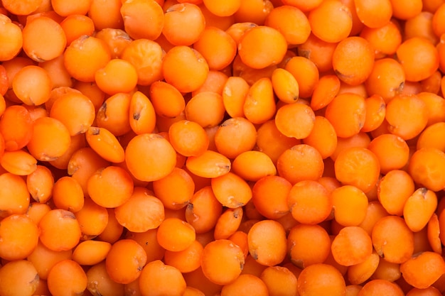 Red lentils heap closeup as a background