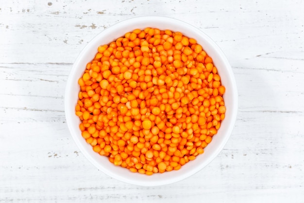 Red lentils raw from above bowl wooden board