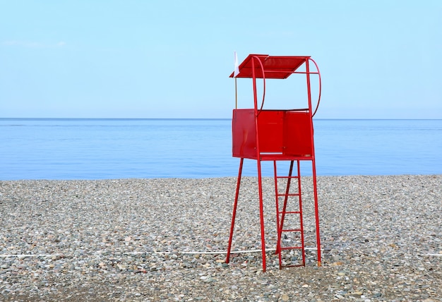 Red lifeguard chair on the empty beach