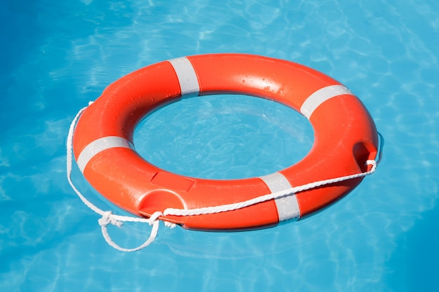 Red lifesaving float on blue water