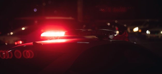 Red light flasher Police car at night time in the city