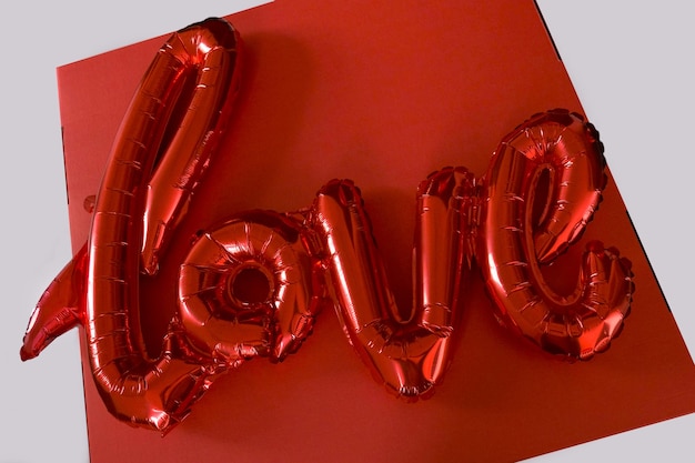 Red love letters valentine day gift balloon gel air top view white backdround