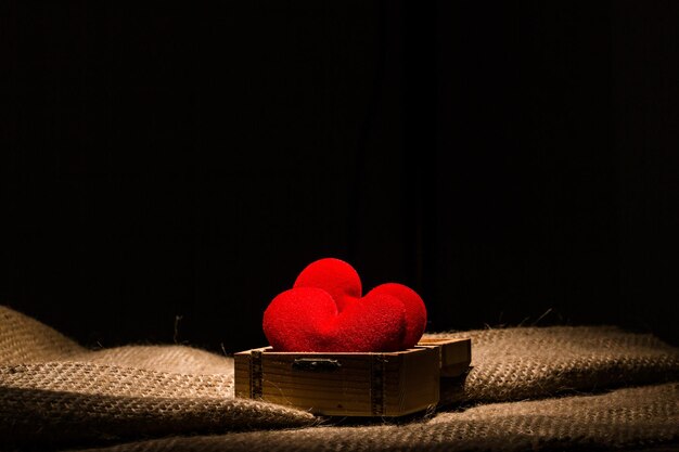 red love valentine heart in wooden treasure box close up.