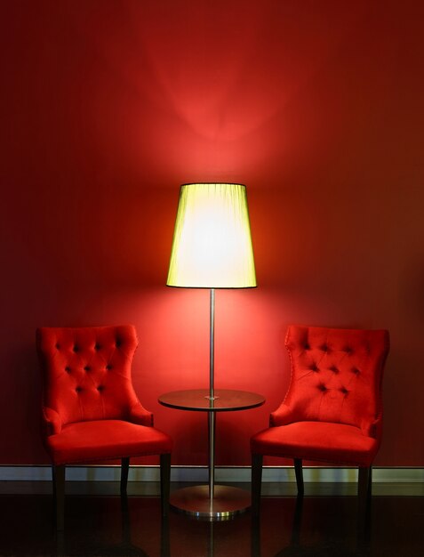 Red luxury chairs with table and lamp