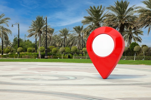 Red Map Pointer Pin in Empty City Street with Palm Trees extreme closeup. 3d Rendering