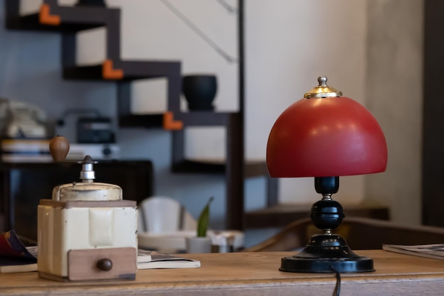 red night lamp standing on wooden table in cafeshop