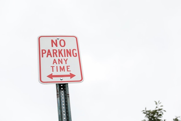 red 'No Parking' sign signifies restricted areas embodying order compliance and traffic control i