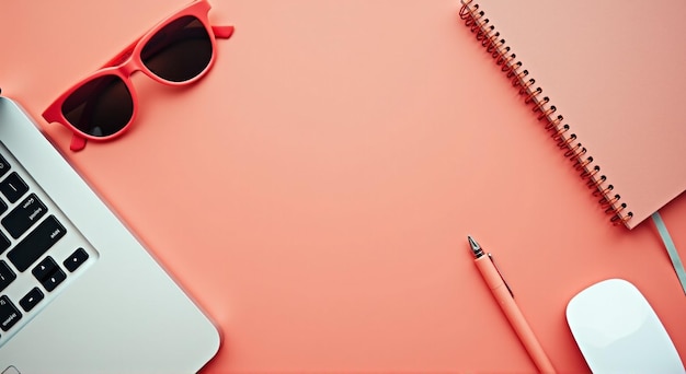 a red notebook with sunglasses and a pencil on a pink desk