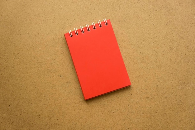 Red notepad for notes with red sheets Blank space for notes Mocap On gray warm ochre kraft background Holiday calendar notes on notepad Background for inscriptions Small notepad with spring