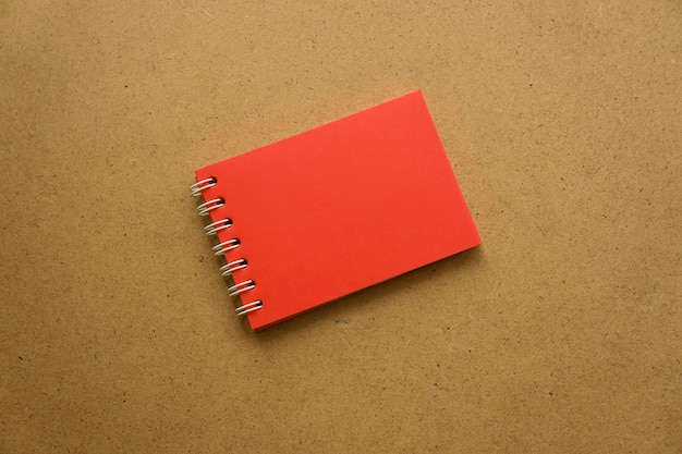 Red notepad for notes with red sheets Blank space for notes Mocap On gray warm ochre kraft background Holiday calendar notes on notepad Background for inscriptions Small notepad with spring