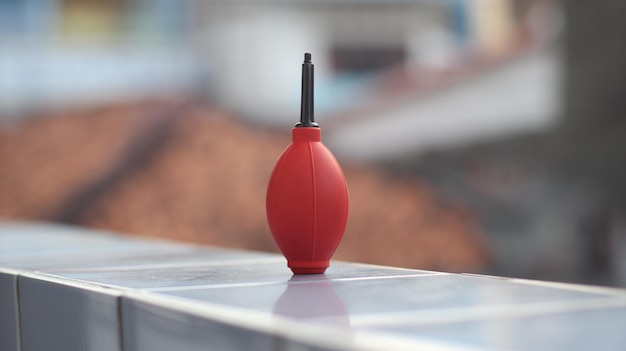 a red object with a black and silver point on the top