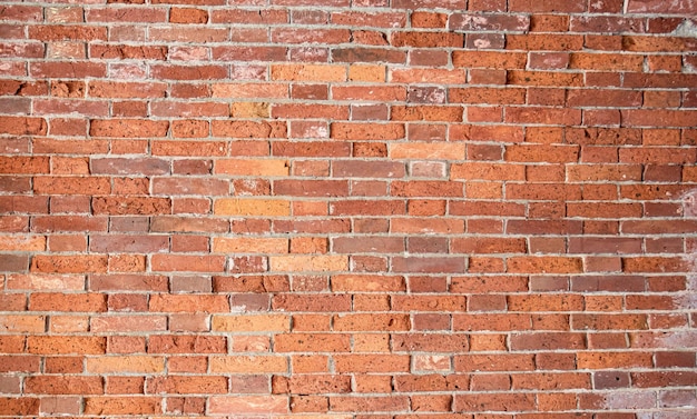 Red old brick wall with gray cement joints