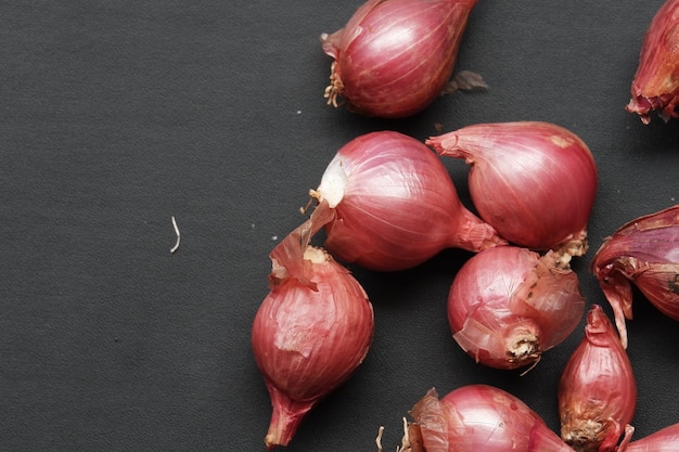 Red onion on black isolated background