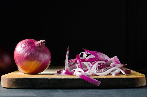 Red onion. Large onion and sliced on a wooden chopping Board