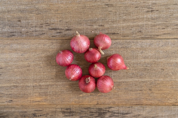 Red onion on shabby wooden board.