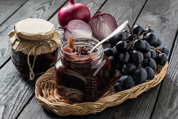 Red onionjam or confiture with grapes and ingredients in wicker basket French cuisine