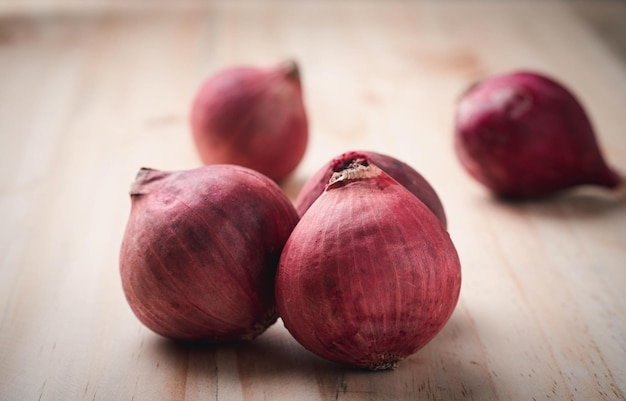 Red onions composition lying on the wooden table