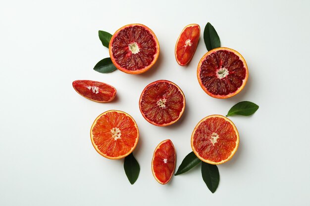 Red orange slices with leaves on white isolated background