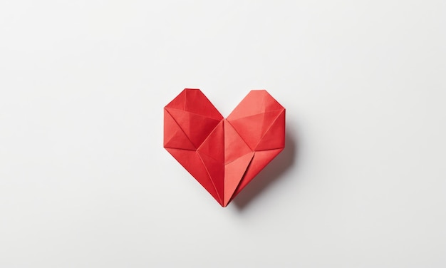 Red origami heart on a white background