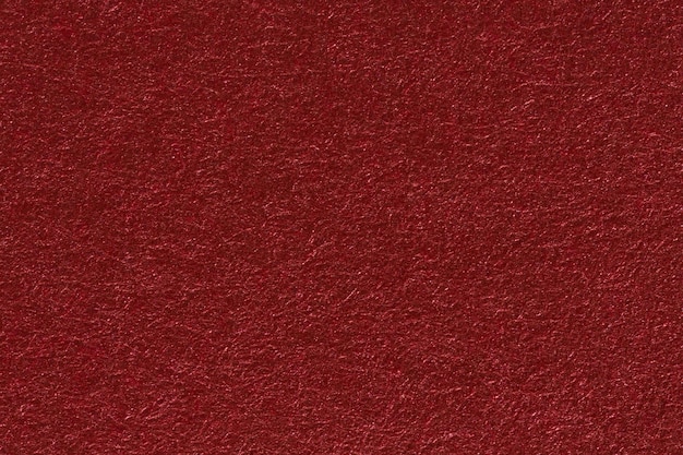 A red paper background with mottled texture. High resolution photo.