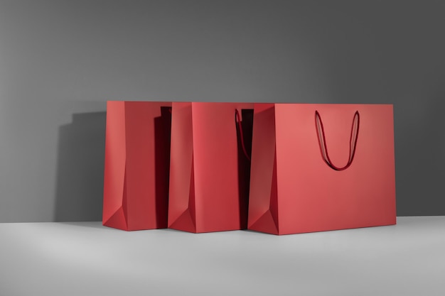 Red paper glossy shopping bag mockup with red handles