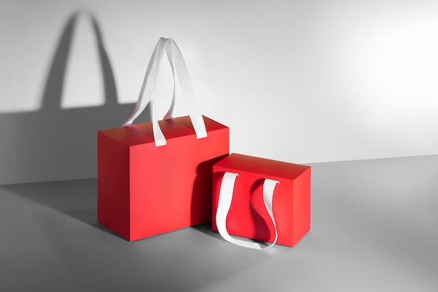 Photo red paper glossy shopping bagbox mockup with white handles