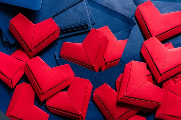 Red paper heart and blue envelope,Love letter idea with blue envelope with red hearts spilling out.