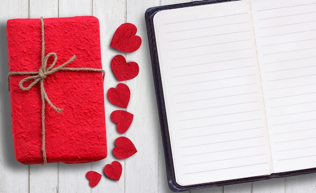 Red paper heart and gift box on wood table