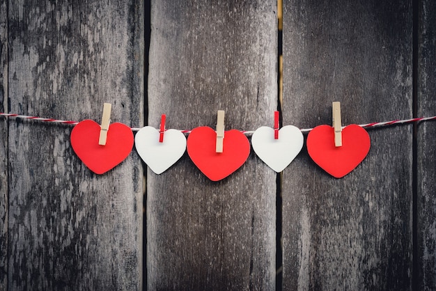 Red paper heart hanging on the clothesline