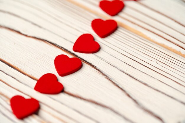 Red paper hearts on wooden background close up photo