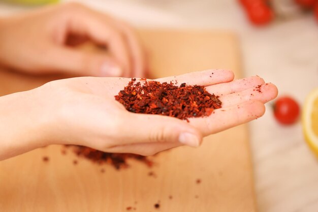 Red paprika on the hand in the kitchen