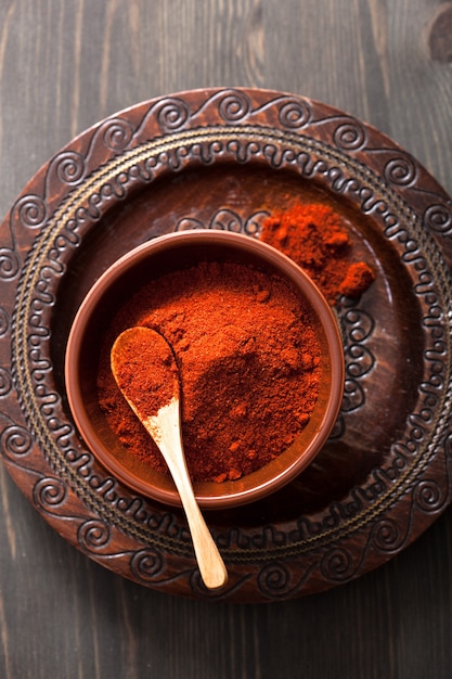 Red paprika powder spice in bowl