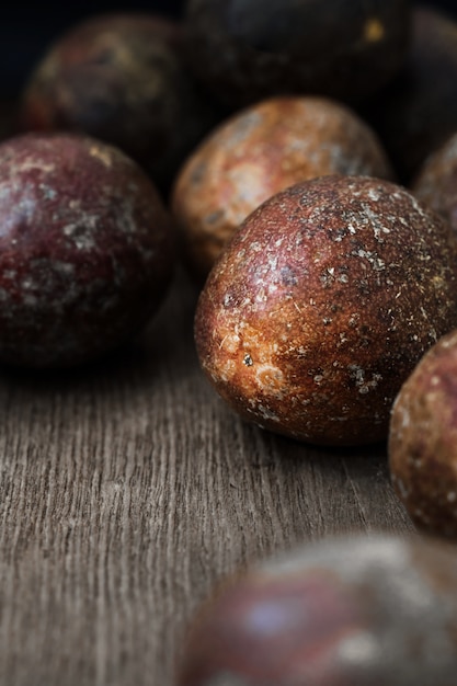 Red passion fruits on old wood background