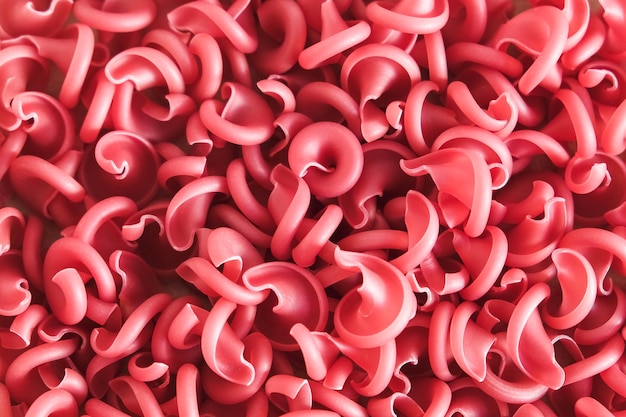 Red pasta as a background image. Top view. Copy, empty space for text