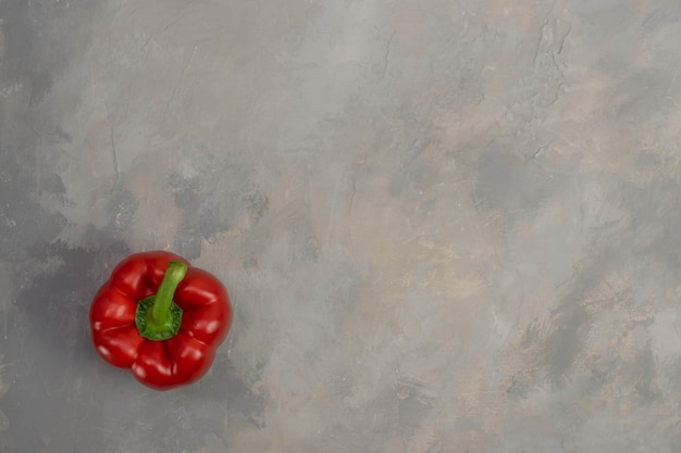 Red pepper on gray stone background. Organic vegetables.