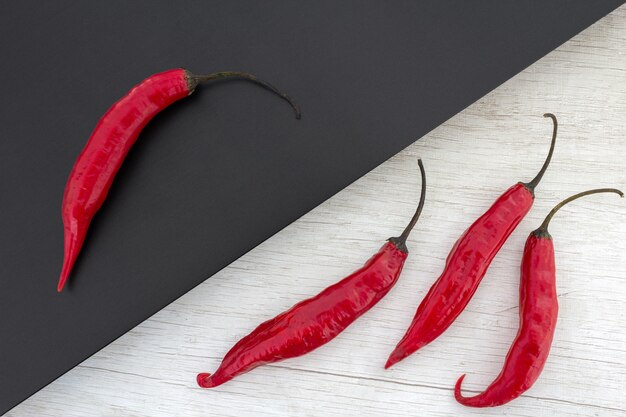 Red peppers on black and white surface