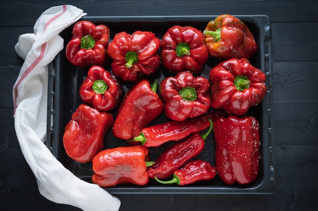 Red peppers on a tray ready to bake.