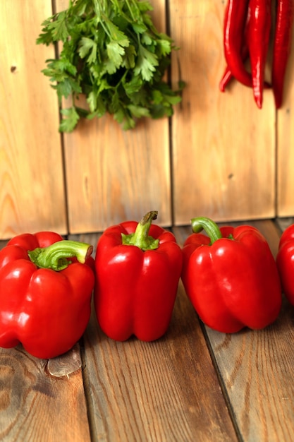 Red peppers on a wooden background