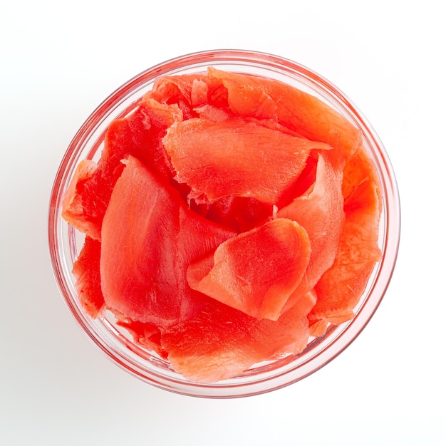 Red pickled ginger in glass bowl isolated on white background with clipping path