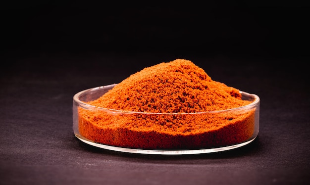 Red pigment powder with black background industrial use in synthetic dyes