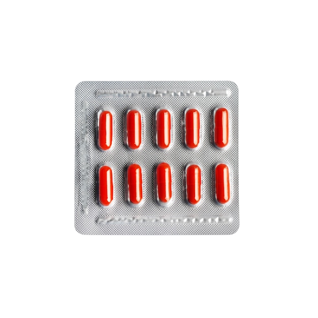 Red pill capsules in blister pack isolated on white