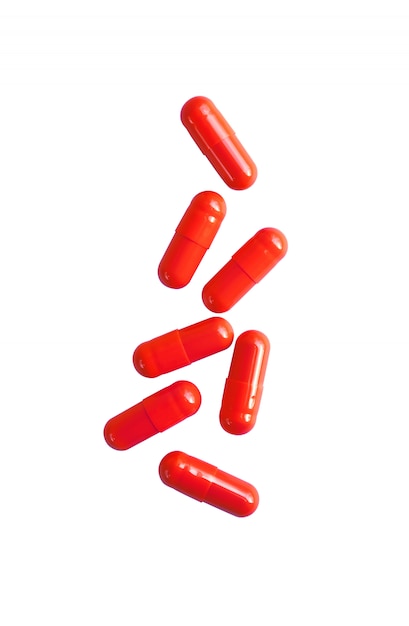 Red pill capsules isolated on white background